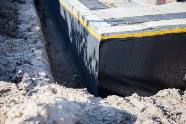 Professional Basement Waterproofing technician working in Heltonville, IN